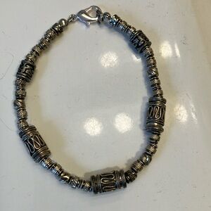 Men’s silver metal beaded 8 1/2” bracelet on stretchy cord with clasp.